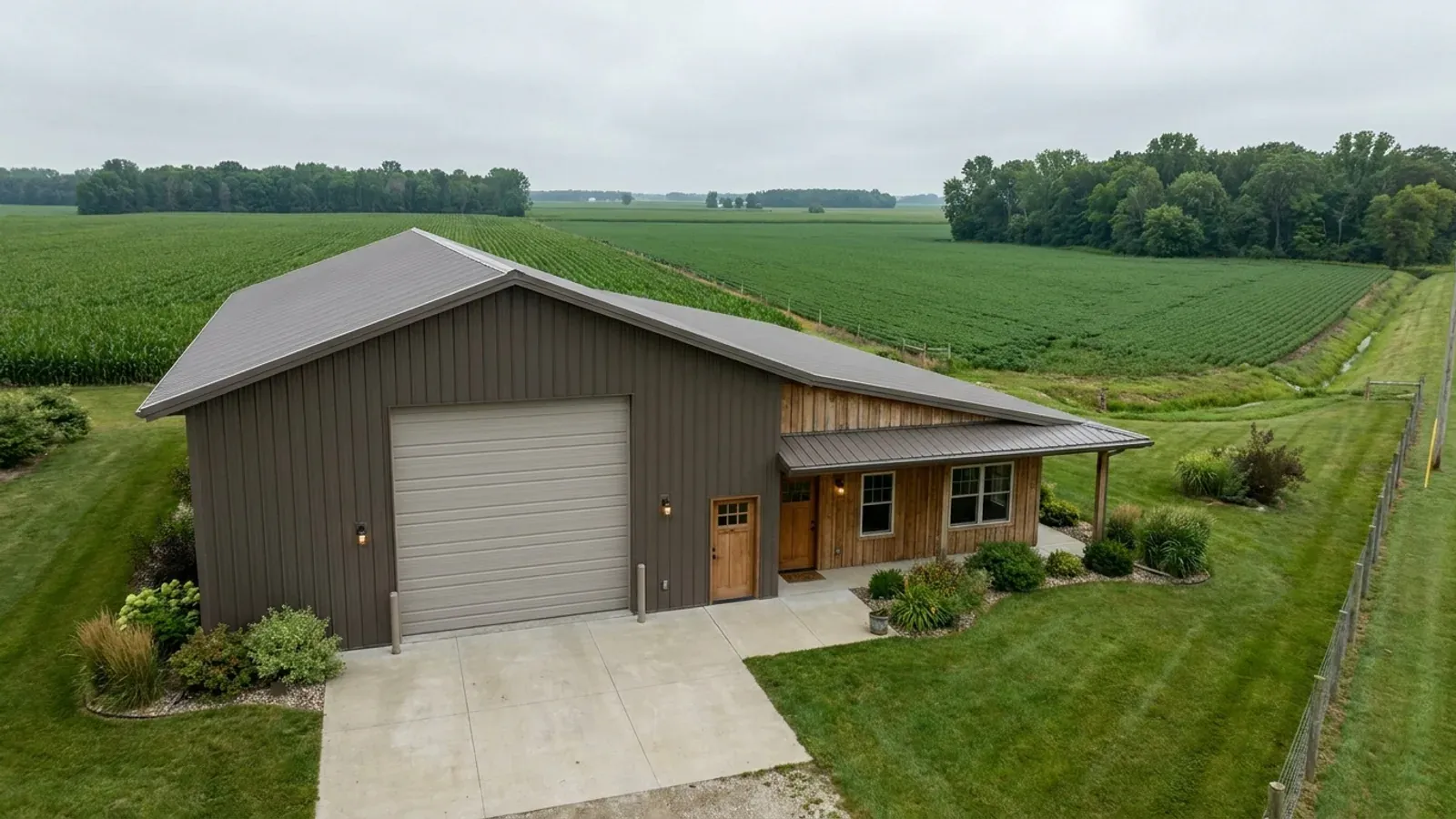 A barndominium with a tall, deep RV garage bay attached to the residence under one continuous roof.